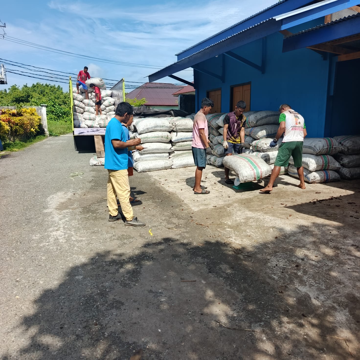 Workers loading coconut product at the factory